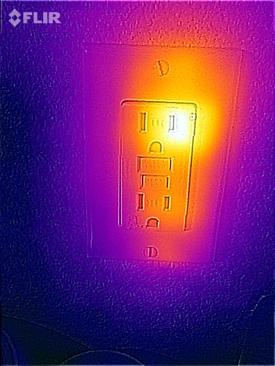 Thermal image of heat loss from an electrical outlet in the living room.